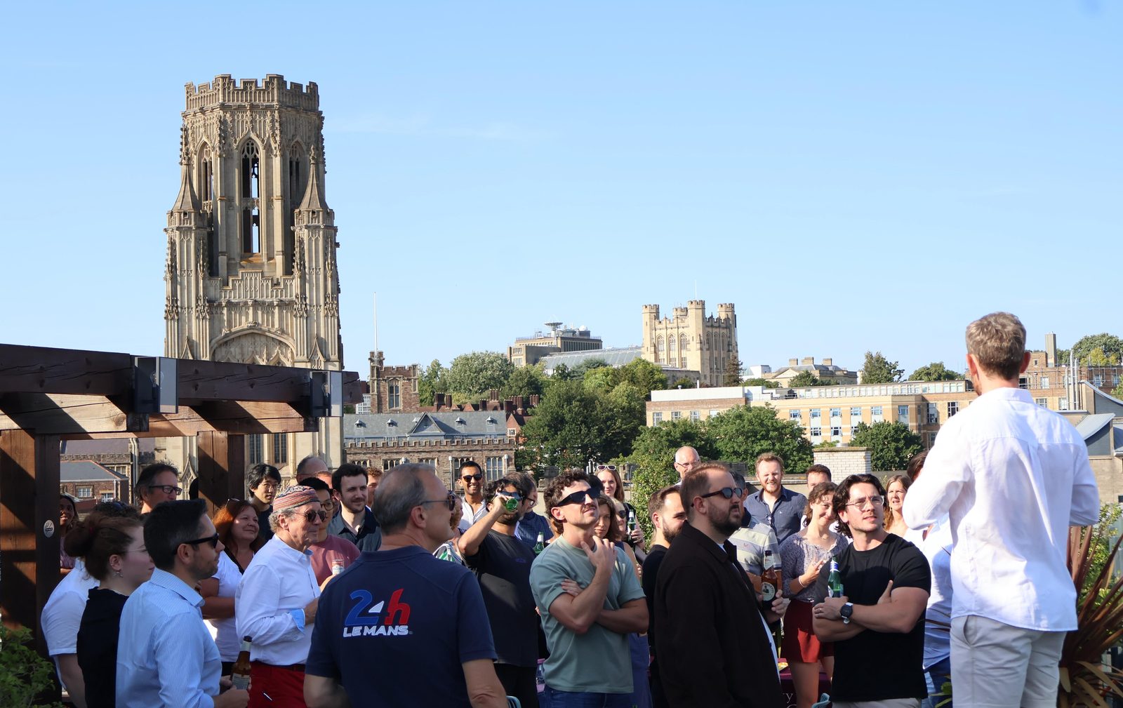 The cohort gathered on the rooftop above Bristol, the Wills Memorial Building and the city skyline behind them.